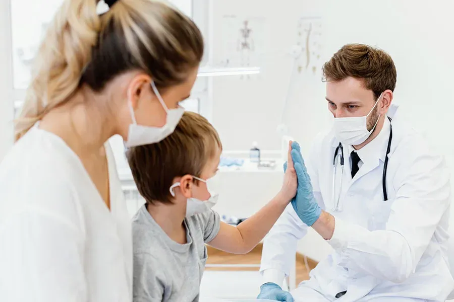 Close-up of a patient and doctor high-five