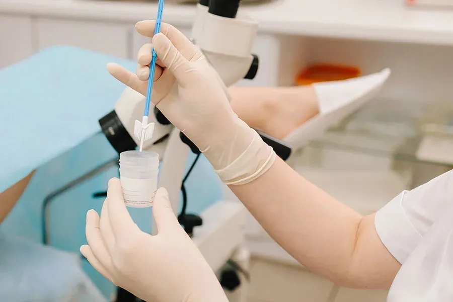 Gloved hands preparing a laboratory sample with a pipette